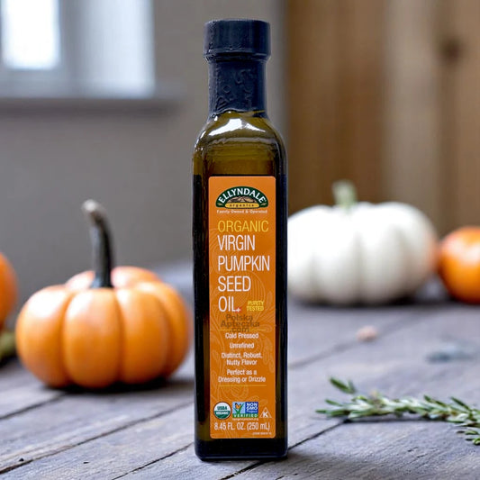 Organic Virgin Pumpkin Seed Oil 250ml bottle by Ellyndale on rustic table with pumpkins – cold pressed, USDA certified, non-GMO